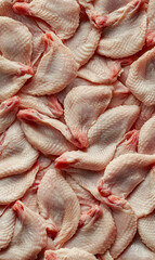 Fototapeta premium Raw chicken wings close up displaying natural color, texture and form in studio light