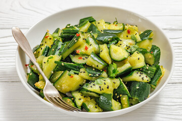 Japanese smashed cucumber salad in a white bowl