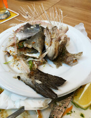 Fish bones lying on a plate after the meal