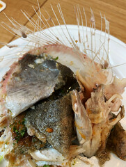 Fish bones lying on a plate after the meal