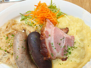 A typical German specialty: a meat platter, schlachtplatte, with liver sausage, crackling,...