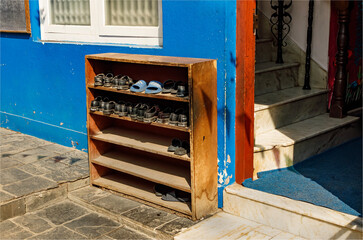 A cupboard full off shoes taken off by the pupils of a school and left outside