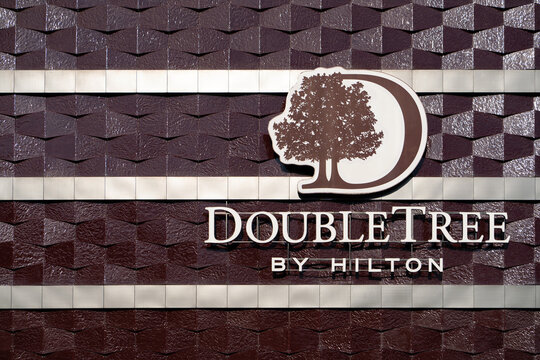 A view of a sign outside the Doubletree By Hilton Hotel. Logo on the facade of the hotel building Double Tree by Hilton Hotel Minsk. Minsk, Belarus - March 4, 2025	