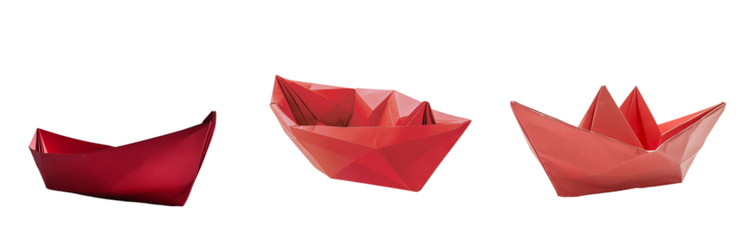 On a transparent background, a red origami boat is shown in isolation, a product of Generative Ai - Powered by Adobe