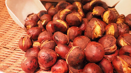 A close up of roasted chestnuts with cracked shells.