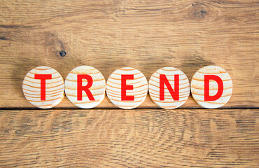 Fototapeta premium Trend and trending symbol. Concept word Trend on beautiful wooden circles. Beautiful wooden table wooden background. Business lifestyle trend and trending concept. Copy space.