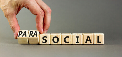 Social or parasocial symbol. Concept words Social or Parasocial on beautiful wooden blocks. Beautiful grey table grey background. Businessman hand. Business social parasocial concept. Copy space.
