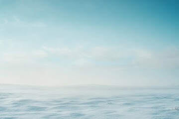 Obraz premium Serene Winter Landscape Under Soft Blue Sky - Vast, snow-covered plains meet a pale blue sky, symbolizing peace, tranquility, isolation, winter's beauty, and boundless horizons