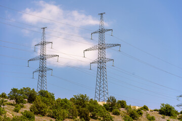 High voltage towers with sky background. Power line support with wires for electricity...