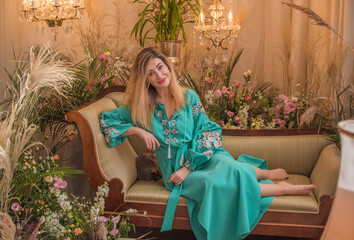 European Slavic woman posing in boho style turquoise dress. Concept of fashion. Hippie style and...