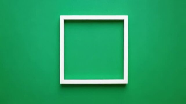 Minimalistic white square frame on green background, copy space
