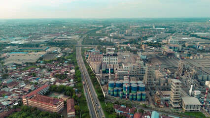 Aerial view of Medan Industrial Park, Indonesia, showcasing factories, highways, and urban development. Perfect for themes of industry, logistics, infrastructure, and economic growth