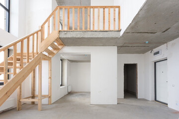 Obraz premium interior of the apartment without decoration in gray colors. rough finish