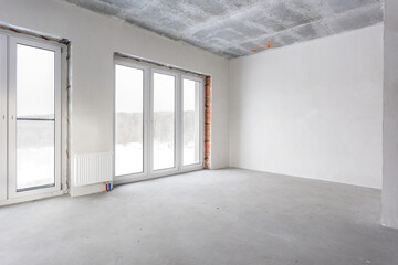Obraz premium interior of the apartment without decoration in gray colors. rough finish