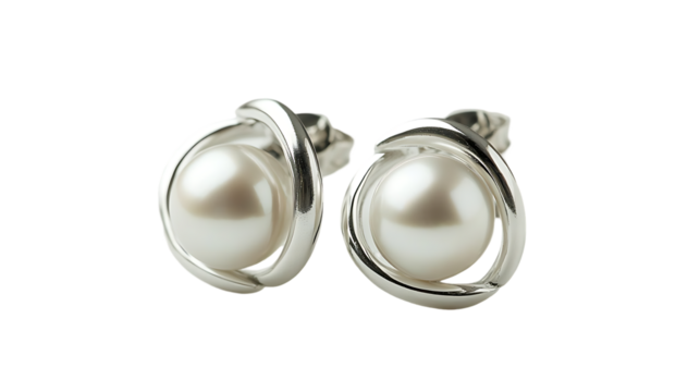 Two pearl earrings with silver wrapping are captured closely