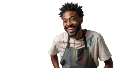 Black man artist or artisan smiling in colorful apron showcasing creativity in art studio