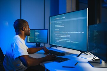 African american IT Programmer Working on Desktop Computer.