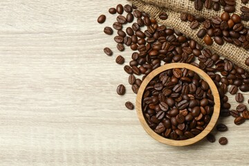 Coffee beans in a bowl on wooden background