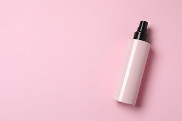 Natural cosmetic products. Cosmetic bottle a pink background, top view