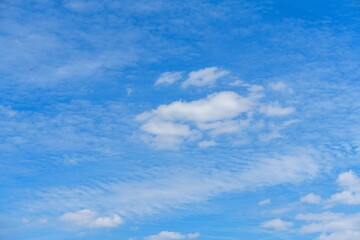 This beautiful image showcases fluffy white clouds against a vibrant blue sky. Ideal for backgrounds, travel brochures, or any design project that needs a serene and uplifting touch.