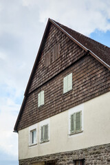 Old house with wooden facade in the town. Traditional german house with upper part of facade with timber trim. 