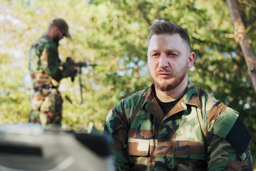 In the field, the army commander communicates via video call with the base leader, relaying mission...