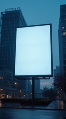 Vertical high-quality shot of a large unlit billboard with glass-covered buildings, darkening sky, sharp cool blue-gray palette, serene mood.