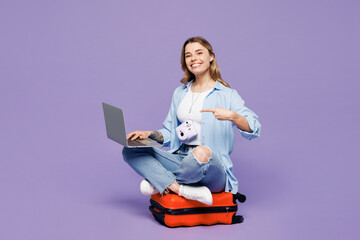 Traveler IT woman wear blue clothes sit on bag use work point on laptop pc computer isolated on...
