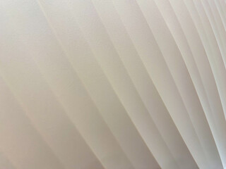 Obraz premium White abstract geometric background with soft light parallel inclined diagonal paper stripes with gradient in simple minimal elegant modern style.