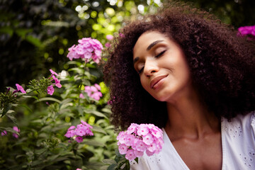 Naklejka premium Photo of lovely charming girl wear white stylish dress enjoy rest near blooming fresh flowers outdoors