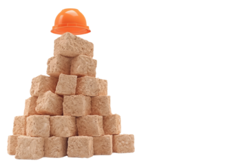 Stacked blocks with a construction helmet on top, representing safety in the workplace.