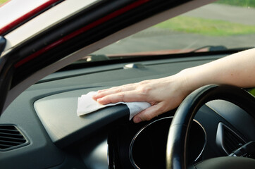 Hand Cleaning Car Dashboard Interior with Cloth