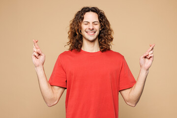 Young smiling fun man he wearing red t-shirt casual clothes waiting for special moment, keeping...