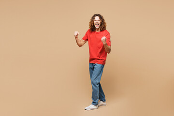 Full body young fun Caucasian man he wear red t-shirt casual clothes doing winner gesture celebrate...