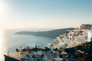 Santorini rooftop terrace, tables, and views.