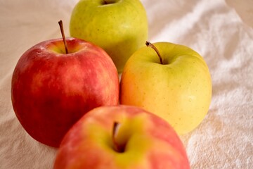 Ripe apples  lie on a white tablecloth