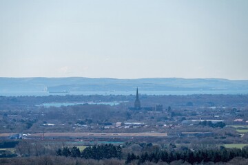 View of Chichester Cathedral across the South Downs National Park  from Halnaker Hill West Sussex England