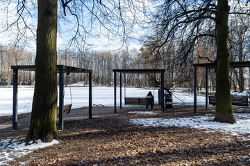 young woman is swinging in a winter park