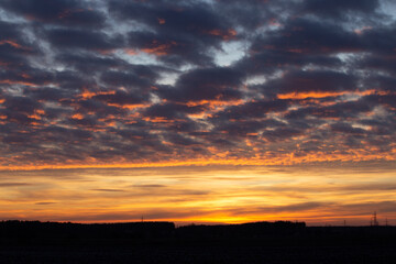 Bright colorful sunset, bright light on the horizon
