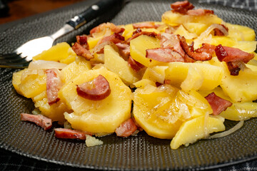 Stewed potatoes with smoked bacon, sausage and onion.