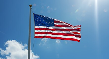 Obraz premium American Flag Waving Proudly in Blue Sky with Sunlight Streaming