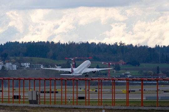 Qatar Airways passenger airplane Airbus A350-900 A7-ALI taking off from Swiss Airport Z&uuml;rich Kloten on a rainy late winter day. Photo taken March 13th, 2025, Zurich Kloten, Switzerland.