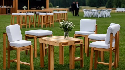 Outdoor event setup features cozy wooden furniture arranged in a lush green space ideal for gatherings during warm summer afternoons