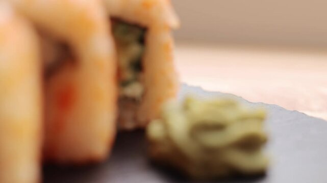 A group of friends savor delicious sushi rolls at a cozy restaurant. The setting features warm lighting and a vibrant atmosphere, perfect for sharing great moments