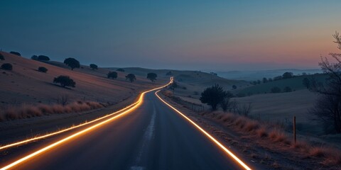 Fototapeta premium Winding Road at Dusk - Rural Landscape with Glowing Edge Lines