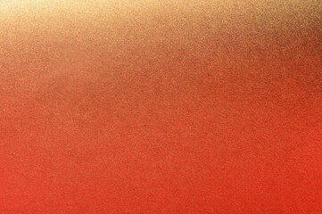 golden spray paint gradient on orange color paper