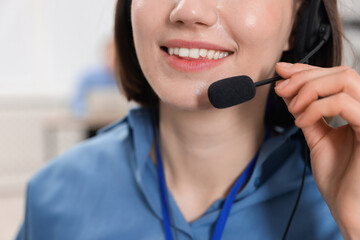 Technical support call center. Smiling operator working on blurred background, closeup