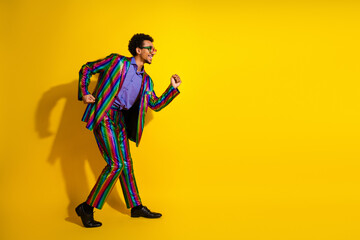 Charismatic young man wearing a colorful suit showcasing dynamic style and confidence against a...