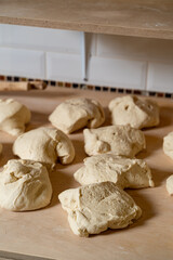 A talented chef skillfully prepares traditional Georgian breads, shaping dough into rustic rounds on a wooden surface. The inviting atmosphere hints at warmth and heritage