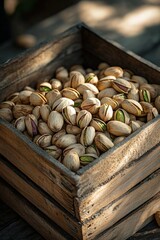 Wooden box spills fresh pistachios on a rustic surface in soft lighting